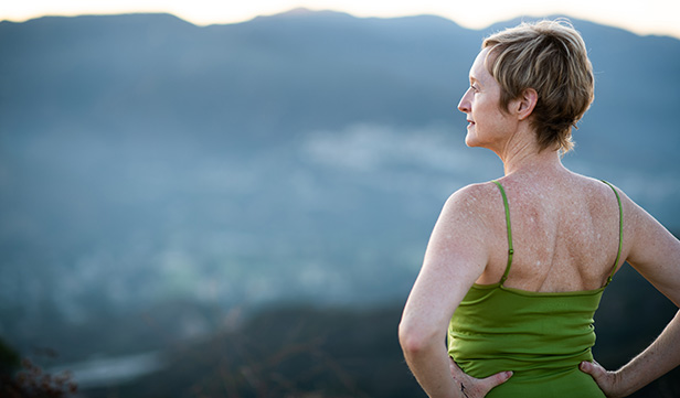 Mature woman enjoys a mountain scene